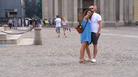 Slow motion of a  couple making a selfie in Piazza San Carlo, Turin Stock Footage 111877507