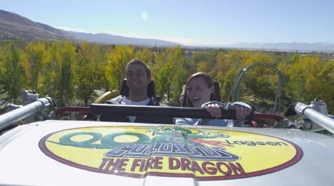 A slow motion of a couple riding a roller coaster. Stock Footage 52263851