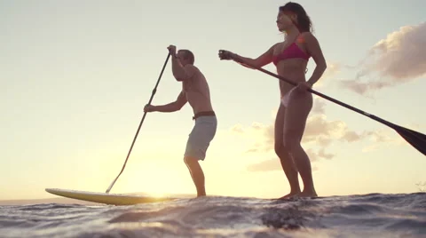 Slow Motion Couple Stand Up Paddle Boarding At Sunset Stock Footage 58472694