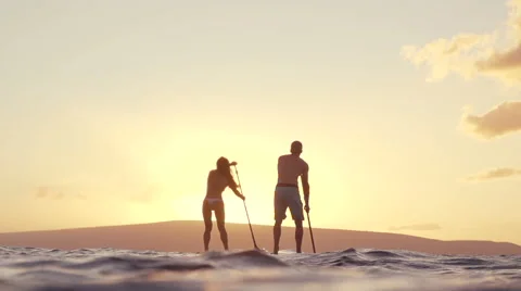 Slow Motion Couple Stand Up Paddle Boarding At Sunset Stock Footage 58490643