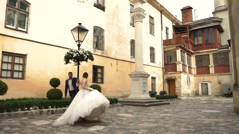 Slow motion. Couple walking holding hands in old european city of Ukraine Stock Footage 96020181