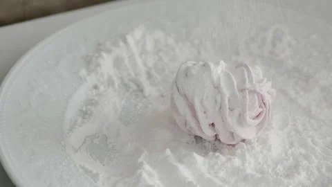 Slow-motion covers marshmallows with powdered sugar Stock Footage 253279937