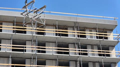 Slow motion of crane fork lowering Staxo scaffolding structure 動画素材 340157374