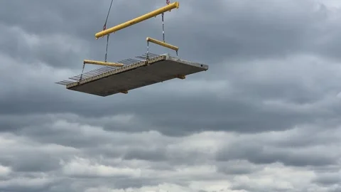 Slow motion of crane positioning precast concrete panel Stock Footage 337847580