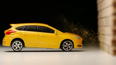 SLOW MOTION: Crash test of yellow toy car - Macro Stock Footage 93241425
