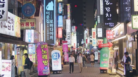 Slow motion of crowd crossing neon-lit street in Seoul at night Stock Footage 314740201