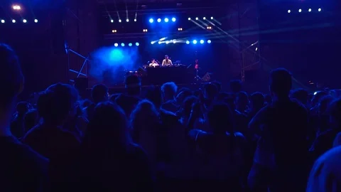 Slow motion of a crowd dancing at a music festival. Silhouettes of concert Stock Footage 93422532