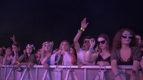 Slow motion of a crowd looking at a concert at a music festival Stock Footage 107449769