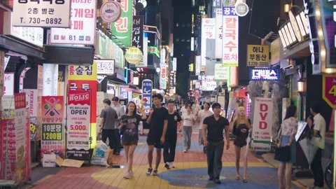 Slow motion of crowded night street with neon glow in Seoul Stock Footage 314740267