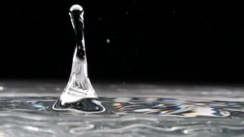 Slow motion, crystal droplets fall into water on a black background Stock Footage 144495591