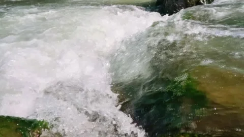 Slow motion of a crystal rocky mountain river flowing rapidly Stock Footage 320920635