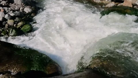 Slow motion of a crystal rocky mountain river flowing rapidly Stock Footage 320920692