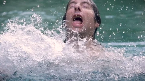 Slow motion CU of a man drowning in water - a swimming pool, lake, or ocean Video stock 58911073