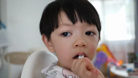 Slow motion, cute boy playful bite a straw Stock Footage 99339353