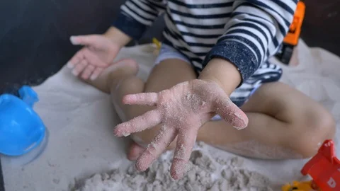 Slow motion, cute child playing sand in playground of pre-kindergarten Stock Footage 99320845