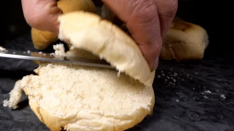 Slow motion – Cutting a bread roll in half. Stock-Footage 108221817