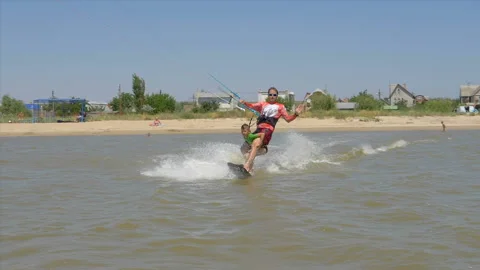 Slow motion. Dad and his son ride on kitesurfing together Stock Footage 92387273