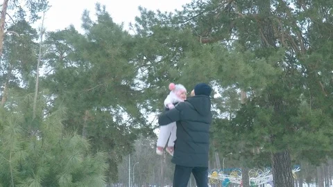 Slow motion, dad throws his daughter up to the sky in the winter forest. Stock Footage 101763366