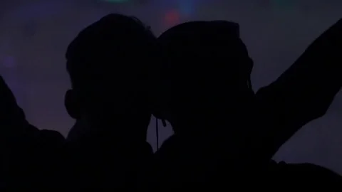 Slow motion dancing silhouette of a DJ and party people. Stock Footage 71007107