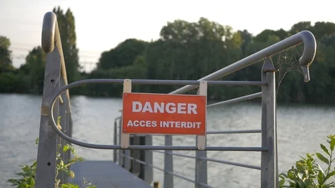 Slow motion of danger sign on the deck of a river Stock Footage 93657192