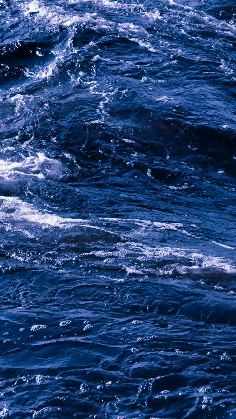 Slow motion dark blue ocean waves with dramatic foam and turbulent motion. 4K Stock Footage 307012435