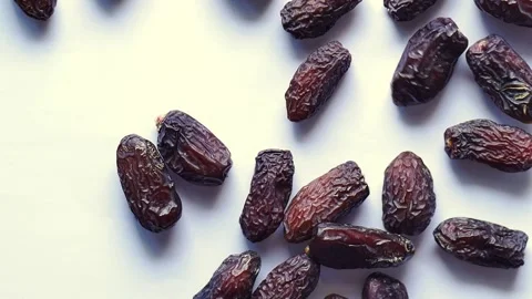 Slow motion of date fruits dropping on white background Stock Footage 244490454