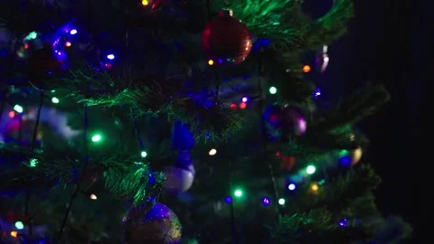 Slow Motion: Decorated Christmas Tree Shines by Colorful Lights. Video stock 167184791