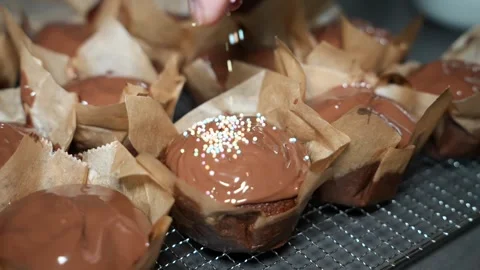Slow Motion Decorating Chocolate Muffins with Sprinkles Video stock 320393626