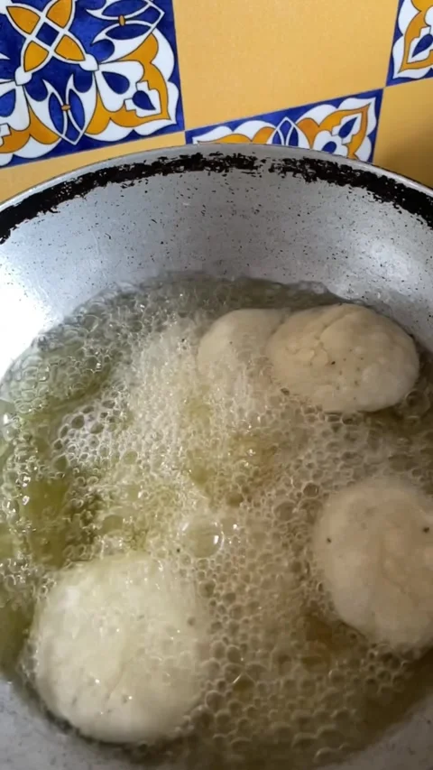 Slow motion of deep frying a snack made with whole wheat flour called mathr.. Stock Footage 338373625