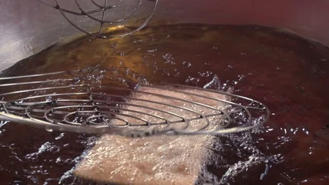Slow motion of deep frying a typical fast,food Brazilian savoury snack of Pastel Stock Footage 108792871