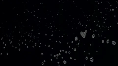 Slow motion defocus water flows slowly down the glass on black background Stock Footage 159810624