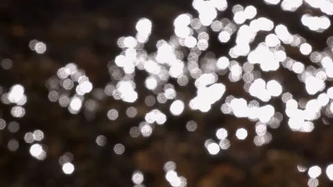 Slow motion of defocused rapid water with play of sun reflection Stock Footage 90565723