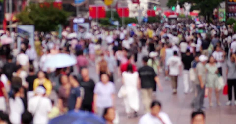 Slow motion defocused view of busy pedestrian street in China Video stock 327648165
