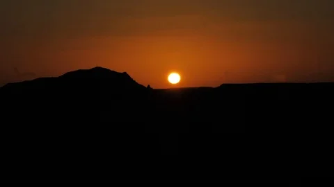 Slow Motion of a desert sunset hiding in the sand dunes. Видео 105821146