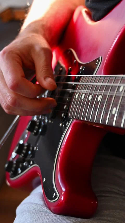 Slow Motion Detail of Hand Fingerpicking Red Electric Guitar Strings Stock Footage 332907257