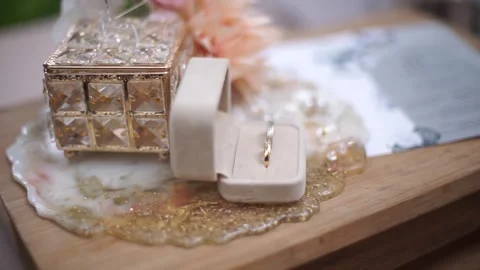 Slow Motion Detailed Shot of Pair of Wedding Rings with Bridal Essentials Stock Footage 341979426