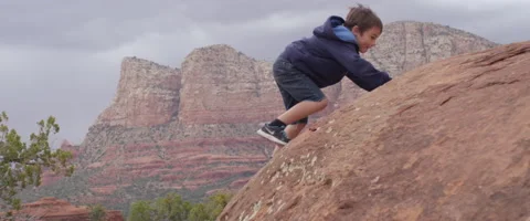 Slow Motion Determined Boy Climbs Boulder Stock Footage 61838547