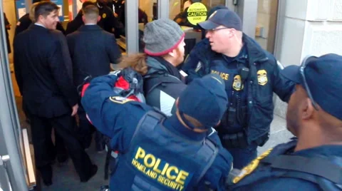 Slow motion of DHS doing crowd control as protesters try to trespass.  Stock Footage 61115437