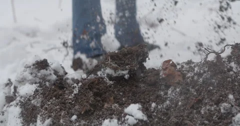 Slow Motion Digging Dirt in Snow Stock Footage 169677886