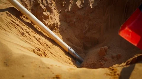 Slow Motion, Digging a hole in desert, moving sand and dirt with a red shovel Stock Footage 306473919