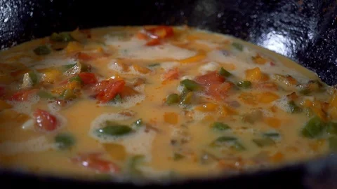 Slow motion, Dinner from eggs and red pepper is cooked in a frying pan. A beauti Stock Footage 102931020