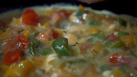 Slow motion, Dinner from eggs and red pepper is cooked in a frying pan. A beauti Stock Footage 102931567