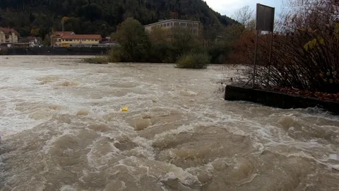 Slow motion dirty rainfall water flowing on small concrete channel Stock Footage 120353690