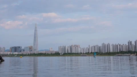 Slow motion of distant Seoul skyline with Lotte Tower and Han River Stock Footage 313674601