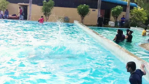 Slow Motion Dive of Indian Man into Pool at Bengaluru Resort Stock Footage 320768105