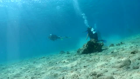 Slow motion of divers on sea bottom. Underwater video Stock Footage 211179582