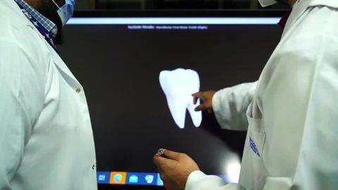 Slow motion of doctors teaching human teeth on vertual screen Stock Footage 199272087