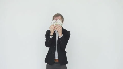 Slow motion of dollar bills falling over the celebrating businessman white Stock Footage 91419000