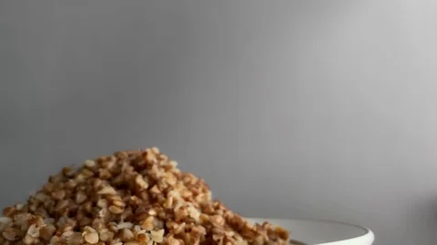 Slow motion. Dolly shot. Cooked buckwheat. Concept of healthy food, vegan, diet Stock Footage 124096291