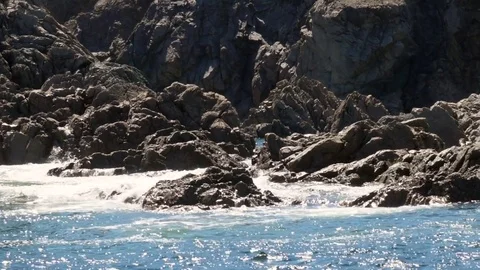 Slow motion dolly shot ocean waves crashing against cliff face Stock Footage 80212610